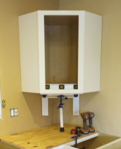 Cabinet Jack, CabiJack 2000 supporting a diagonal corner wall cabinet.
