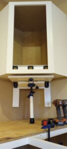 Cabinet Jack, CabiJack 2000 supporting a diagonal corner wall cabinet.